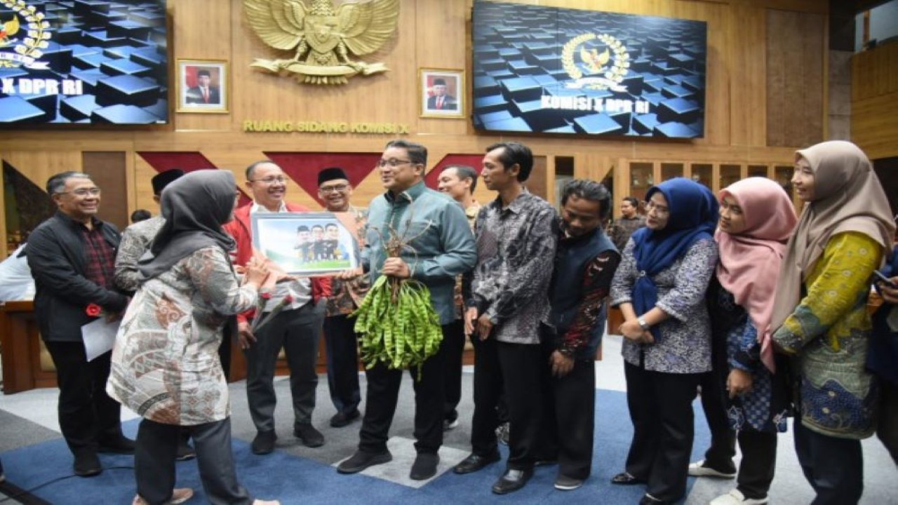 Wakil Ketua Komisi X DPR RI Dede Yusuf diberi hadiah sebelum Rapat Dengar Pendapat Umum (RDPU) dengan FGHNLPSI di Gedung Nusantara I, Senayan, Jakarta, Rabu (17/1/2024). Foto : Devi/Man